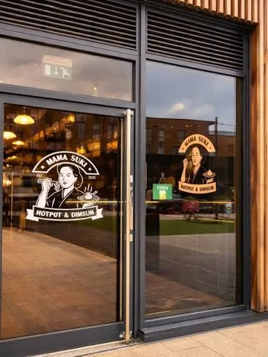 The Mama Suki shopfront at The Riverside, with the Mama Suki logo on the glass doors
